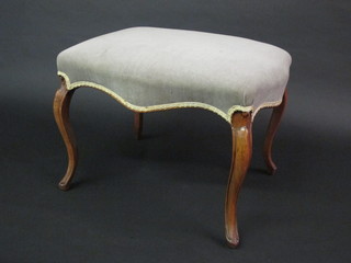 A Victorian shaped walnut stool of serpentine outline with mushroom coloured upholstered seat 25"