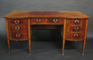 An Edwardian inlaid mahogany writing table, the shaped top  fitted 1 long and 6 short drawers, raised on square tapering  supports 60"  ILLUSTRATED