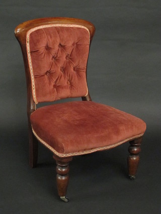 A Victorian mahogany show frame nursing chair with  upholstered buttoned seat and back, raised on turned supports