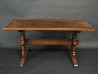 An oak refectory dining table with panelled top, raised on  standard end supports with H framed stretcher 60"