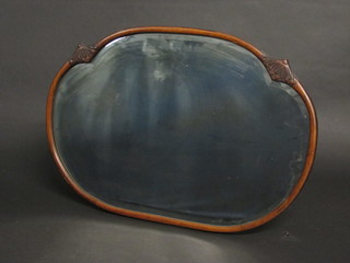 A 1930's Art Deco oval plate bevelled wall mirror contained in a carved walnut frame 30"