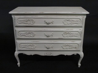 A Continental white painted carved chest of 3 long drawers,  raised on cabriole supports 36"