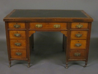 An Edwardian walnut kneehole pedestal desk with inset writing surface above 1 long and 8 short drawers 48"