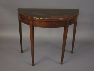 A Georgian mahogany demi-lune card table, raised on square tapering supports ending in spade feet