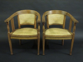 A pair of Oriental hardwood tub back chairs with woven cane  seats and backs