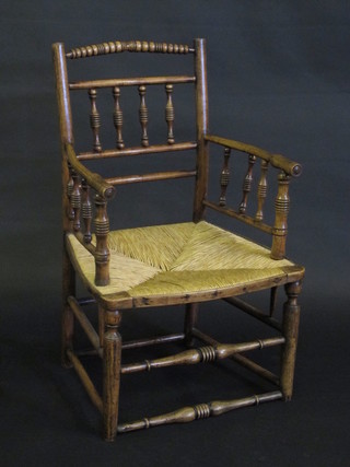 An 18th/19th Century elm stick back chair with bobbin turned decoration and woven cane seat