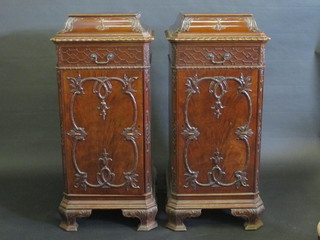 A pair of Georgian style mahogany pedestals with blind fred  decoration fitted a drawer above a cupboard, raised on ogee bracket feet 21" 600-800 ILLUSTRATED