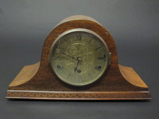 A 1930's chiming mantel clock with engraved gilt dial and  Roman numerals contained in an oak Admiral's hat shaped case