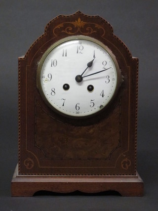 An Edwardian 8 day striking mantel clock with enamelled dial  and Arabic numerals contained in an arch inlaid mahogany case,  raised on bracket feet 8"