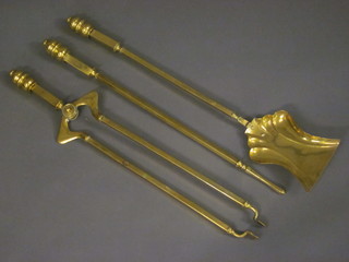 An Edwardian Art Nouveau brass 3 piece fireside companion set comprising shovel, poker and tongs