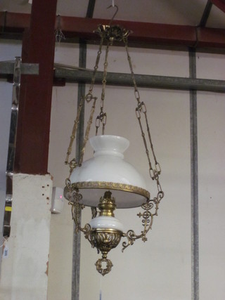 A Victorian style gilt metal and opaque glass hanging oil lamp  with glass shade, cracked,