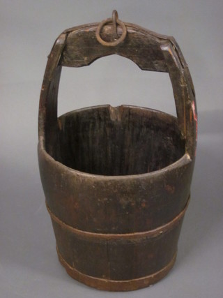 A circular wooden well bucket