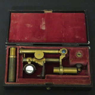 An 18th/19th Century student's brass single pillar microscope contained in a leather carrying case 5 1/2"