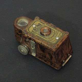 A Coronet midget camera contained in a brown Bakelite case