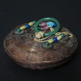 An Oriental circular basket work trinket box with jade coloured handle 4"