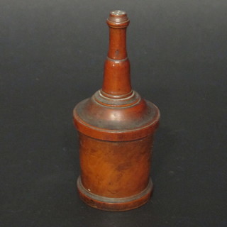 A cylindrical turned fruit wood powder dispenser 5"