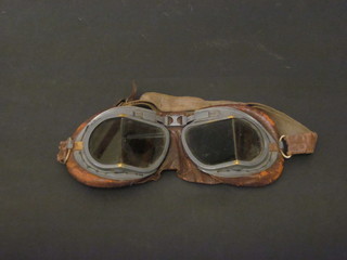 A pair of glass and leather goggles