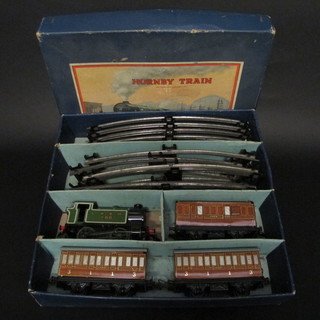 A Hornby O gauge clockwork train set comprising tank engine, 4  carriages and rails, boxed