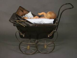 A childs pram containing 2 dolls