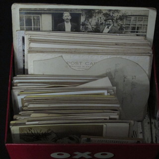 An Oxo tin containing various postcards