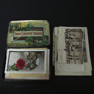 A tin containing a collection of birthday cards and postcards