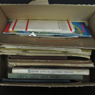 A box containing various cycling maps, route planners etc