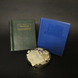 A green Movaleaf stamp album, a blue Stanley Gibbons  Swiftsure album and a circular tin of stamps