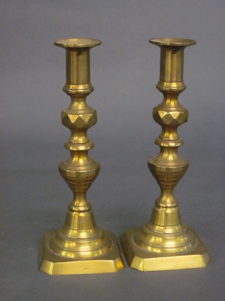 A pair of brass candlesticks with knopped stems 9"