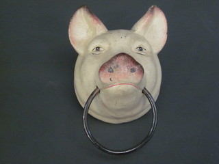 A cast iron wall mounting towel rail in the form of a pigs head, 5"