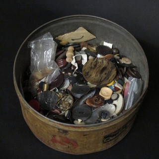 A metal Quality Street tin containing a collection of buttons