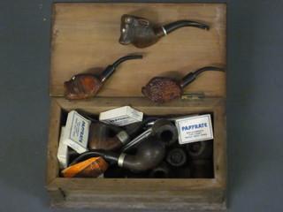 A collection of pipes contained in a wooden box with hinged lid