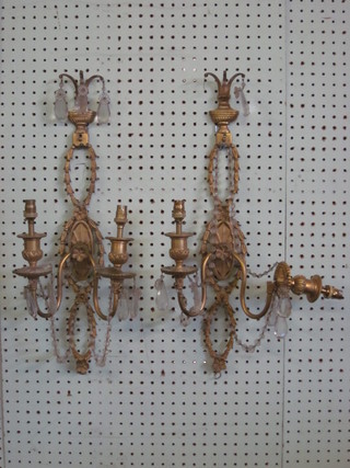 A pair of gilt metal wall light brackets