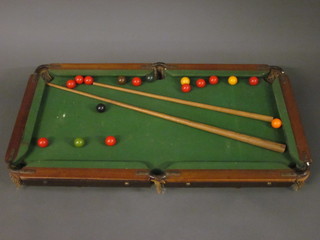 A  table top slate based snooker table 39" x 21", raised on  turned supports, complete with 2 cues and balls