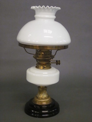 An opaque white glass oil lamp and shade