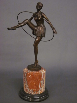 An Art Deco style bronze figure of a dancing girl with hoop  raised on a circular marble base 19"