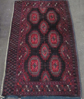 A "Bokhara" red ground rug with 10 octagons to the centre  within multi-row border 67" x 41"