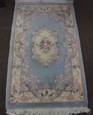 A Chinese blue ground and floral patterned rug 61" x 35"