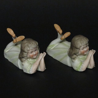 A pair of biscuit porcelain figures of reclining girls 5", 1 f and r,