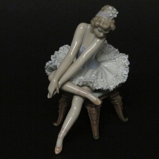 A Lladro figure of a seated ballerina 6" high