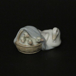 A Lladro figure of a seated goose and basket of goslings 3"