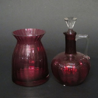 A cranberry glass ewer and stopper with clear glass handle 7", together with a waisted cranberry glass vase 6"