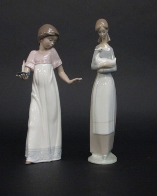 A Nao figure of a standing girl with chamber stick 10" and 1 other standing girl with duck 10"