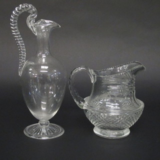 A glass ewer raised on a circular spreading foot 12" and a cut  glass jug 6 1/2"