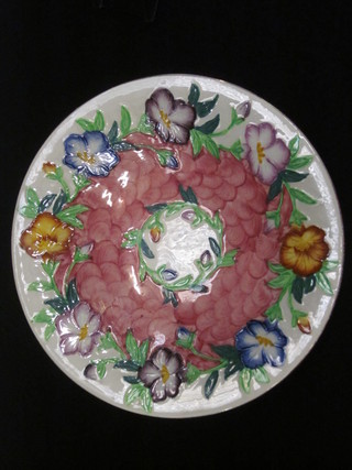 A circular Malingware dish with floral decoration 11"