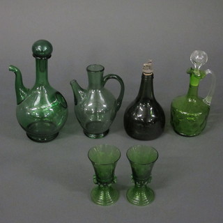 A green glass ewer and stopper with clear glass handle 10", a  green musical wine bottle, 2 green glass ewers and 2 green  glasses