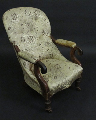 A Victorian mahogany open armchair with upholstered seat and back, raised on turned supports