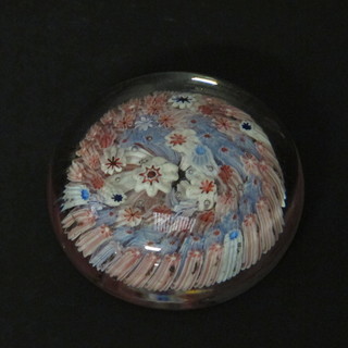 A circular glass paperweight with Millefiouri style decoration 3"