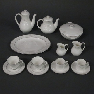 A 58 piece Royal Doulton Mystique pattern tea/dinner service comprising oval meat plate 13", 2 twin handled tureens and  covers 8", 6 dinner plates 10 1/2", 6 side plates 8", sauce boat  and stand, 6 pudding bowls 7", twin handled plated 9 1/2", 6 tea  plates 6 1/2", teapot, milk jug, lidded sucrier, 6 tea cups and 6  saucers, coffee pot, cream jug, 6 coffee cups and 6 saucers