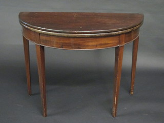 A Georgian mahogany demi-lune tea table, raised on square tapering supports 37"
