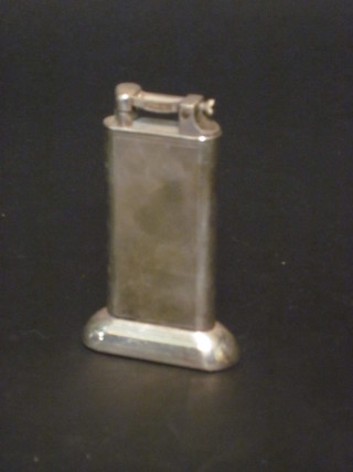 A Dunhill silver plated table lighter with engine turned decoration